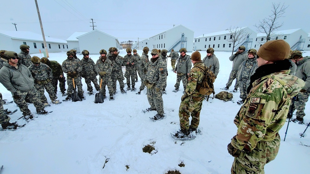 Airmen learn to build Arctic 10-person tents during cold-weather training at Fort McCoy