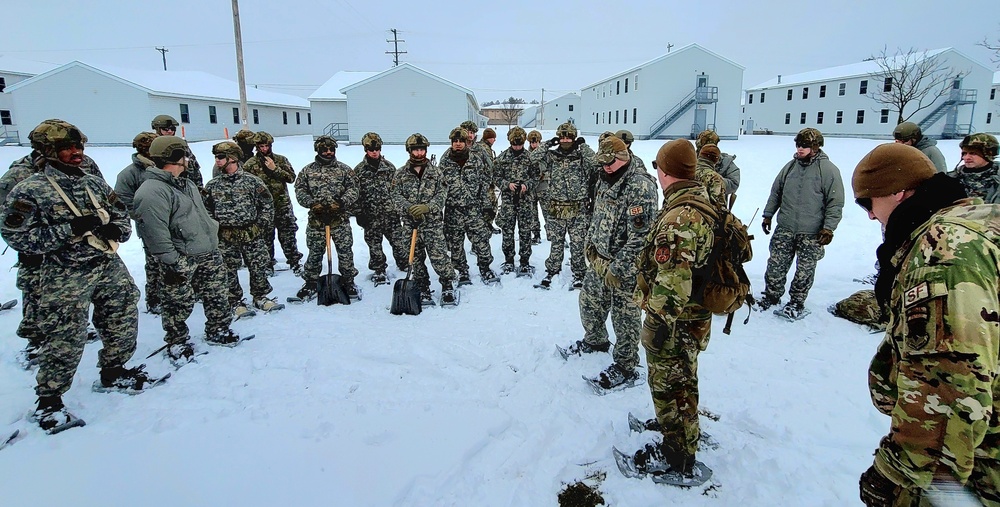 Airmen learn to build Arctic 10-person tents during cold-weather training at Fort McCoy