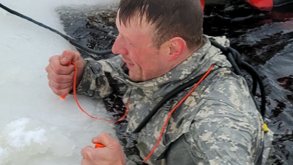 Airmen jump in for cold-water immersion training as part of Air Force-led Cold-Weather Operations Course at Fort McCoy