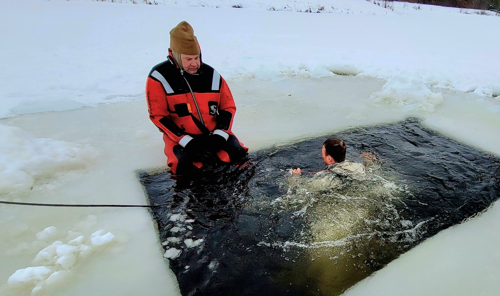 Airmen jump in for cold-water immersion training as part of Air Force-led Cold-Weather Operations Course at Fort McCoy