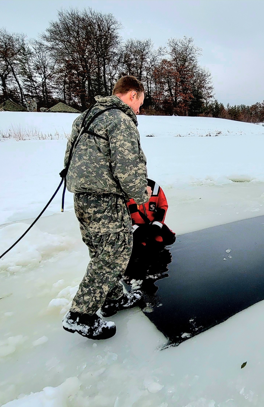 Airmen jump in for cold-water immersion training as part of Air Force-led Cold-Weather Operations Course at Fort McCoy