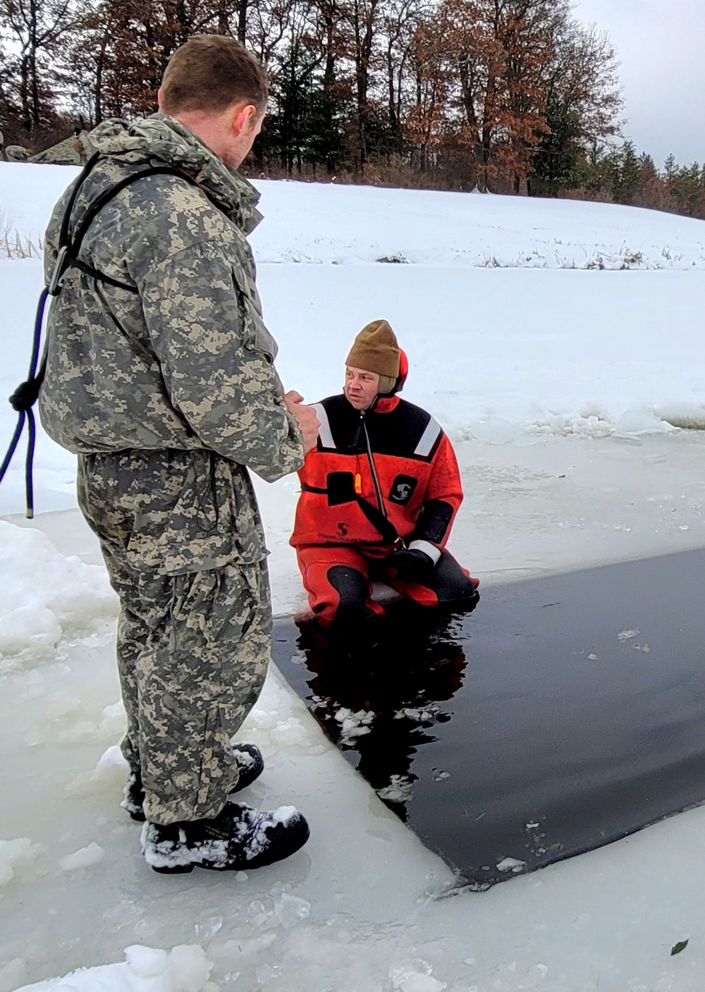 Airmen jump in for cold-water immersion training as part of Air Force-led Cold-Weather Operations Course at Fort McCoy