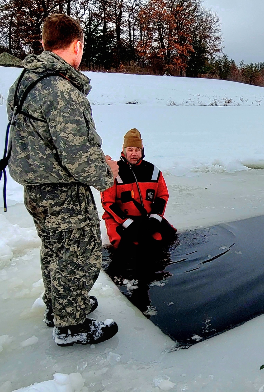 Airmen jump in for cold-water immersion training as part of Air Force-led Cold-Weather Operations Course at Fort McCoy