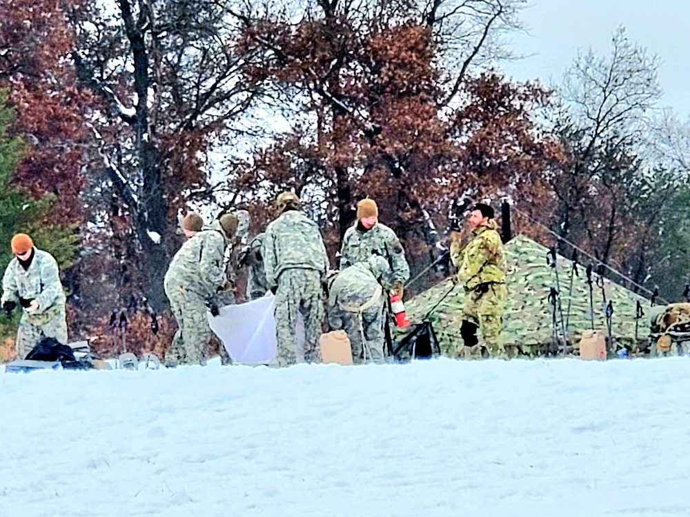 Airmen learn to build Arctic 10-person tents during cold-weather training at Fort McCoy