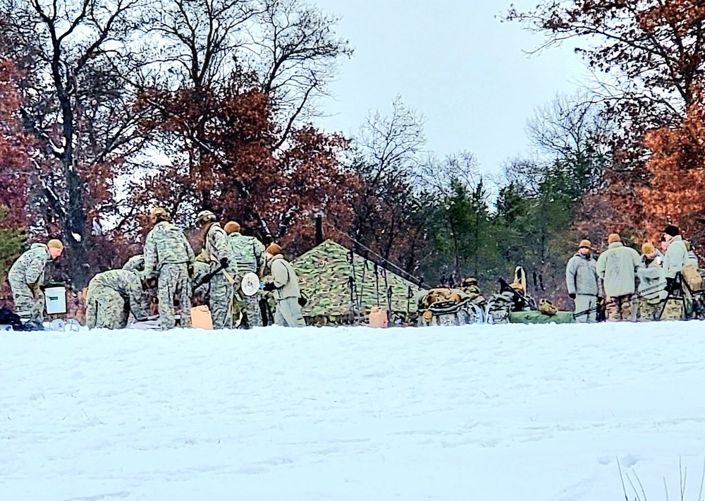 Airmen learn to build Arctic 10-person tents during cold-weather training at Fort McCoy