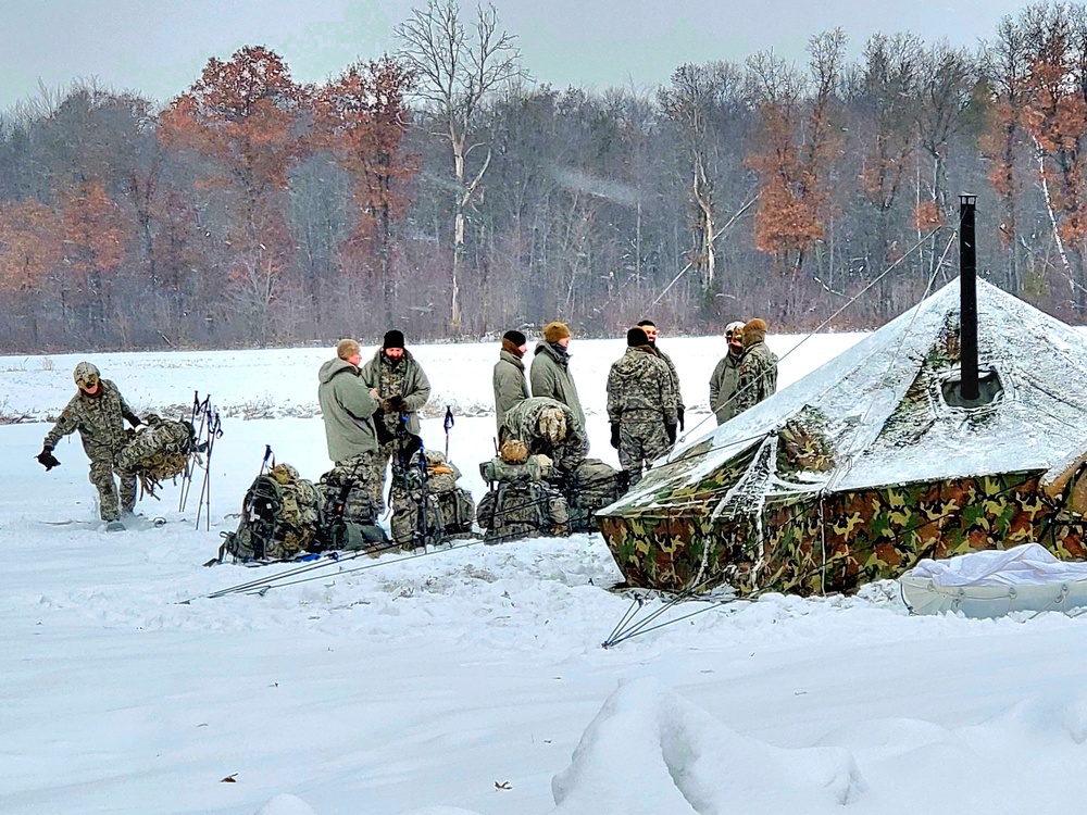 Airmen learn to build Arctic 10-person tents during cold-weather training at Fort McCoy