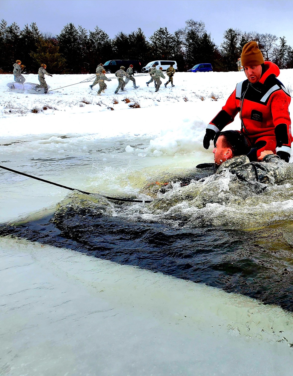 Airmen jump in for cold-water immersion training as part of Air Force-led Cold-Weather Operations Course at Fort McCoy