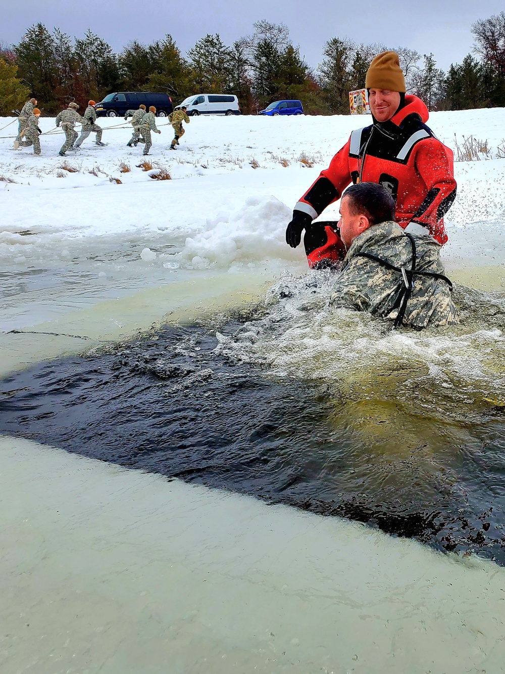 Airmen jump in for cold-water immersion training as part of Air Force-led Cold-Weather Operations Course at Fort McCoy