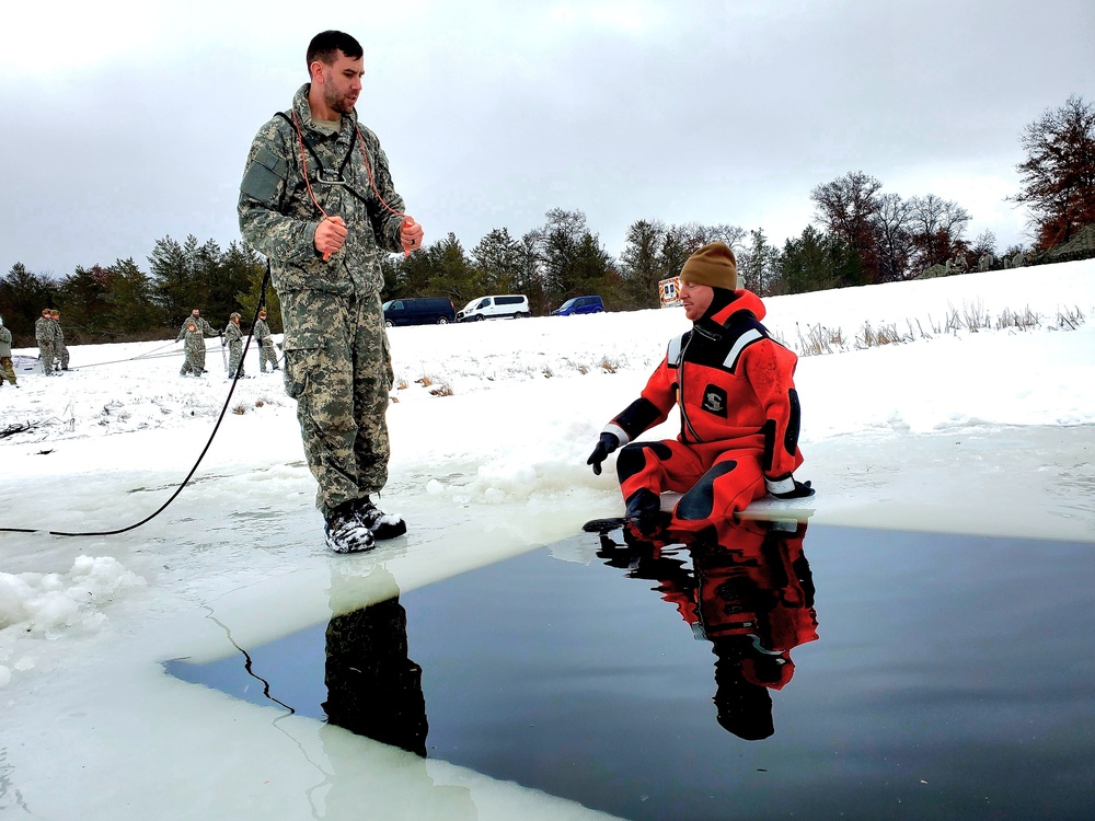 Airmen jump in for cold-water immersion training as part of Air Force-led Cold-Weather Operations Course at Fort McCoy