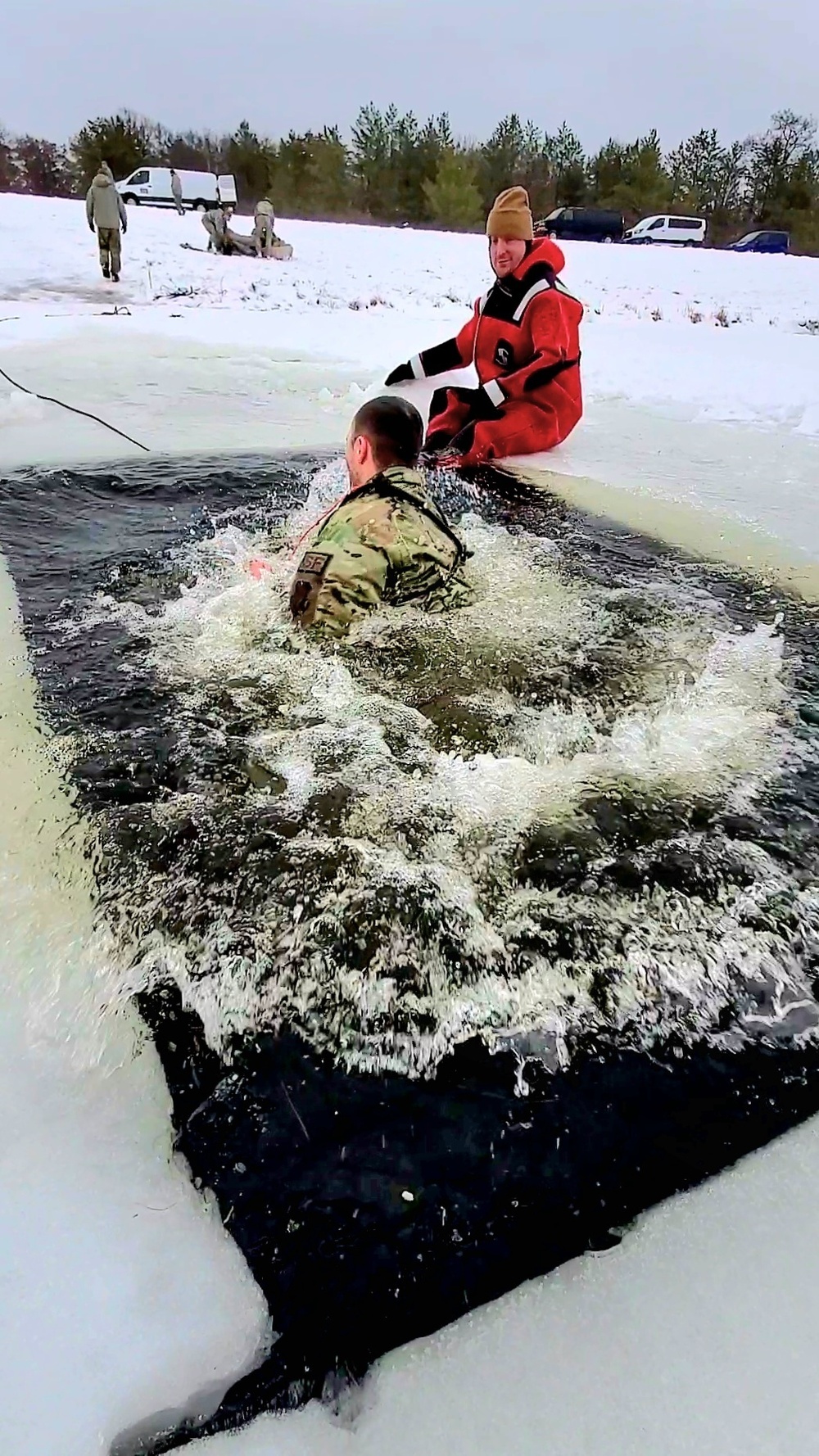 Airmen jump in for cold-water immersion training as part of Air Force-led Cold-Weather Operations Course at Fort McCoy