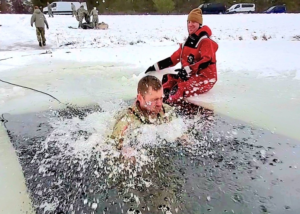 Airmen jump in for cold-water immersion training as part of Air Force-led Cold-Weather Operations Course at Fort McCoy