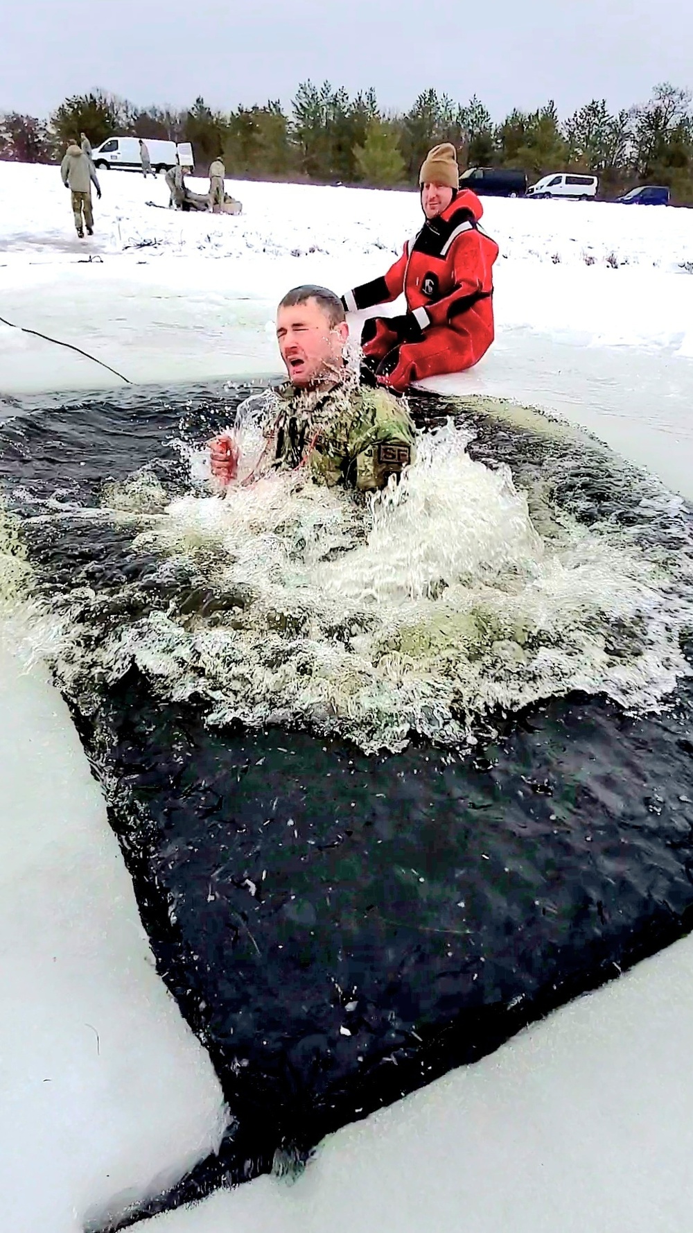 Airmen jump in for cold-water immersion training as part of Air Force-led Cold-Weather Operations Course at Fort McCoy