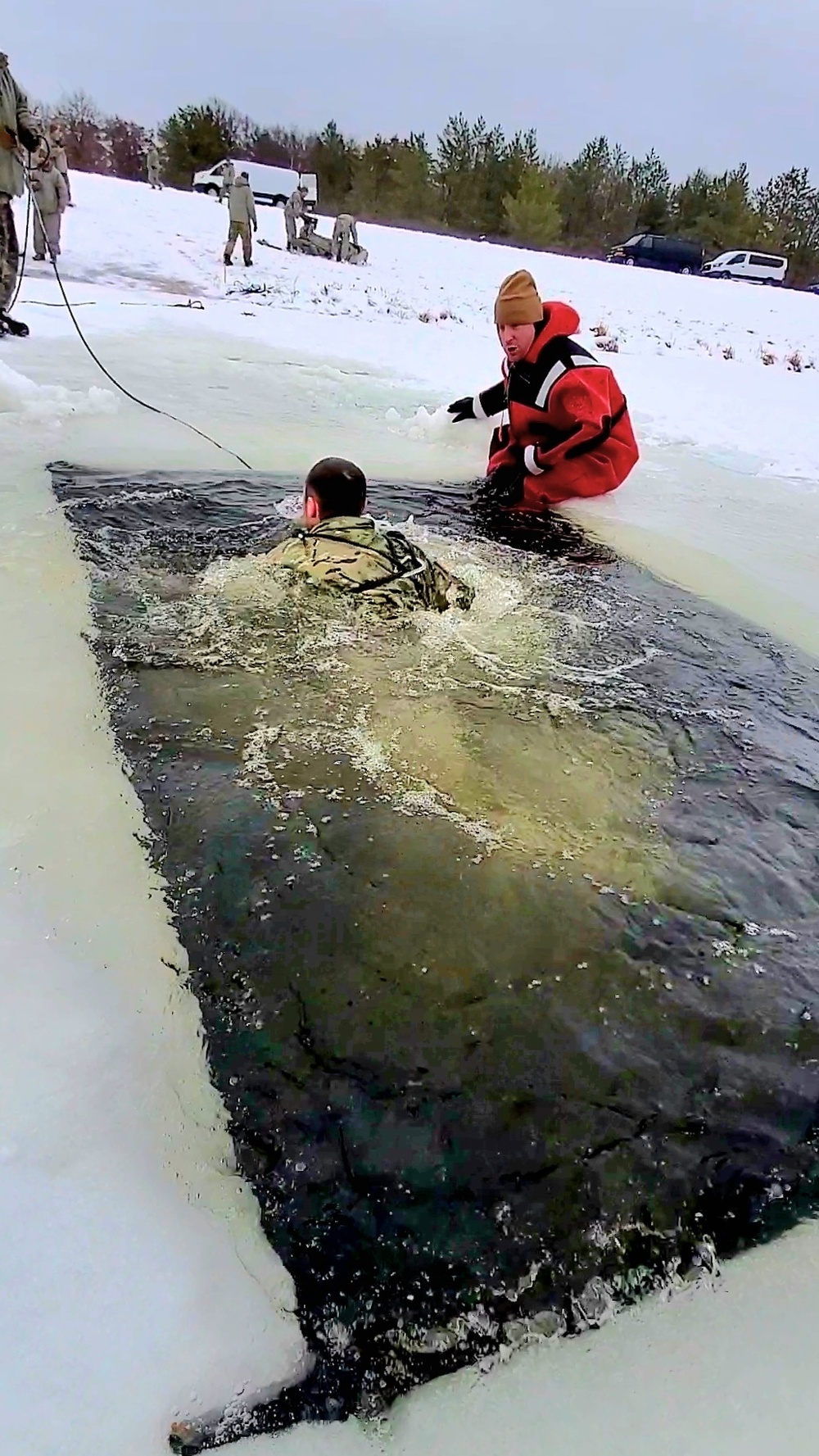 Airmen jump in for cold-water immersion training as part of Air Force-led Cold-Weather Operations Course at Fort McCoy