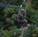 Marine helps fellow trainee return to the 2 strand bridge during the E-cores at Jungle Warfare Training Center.