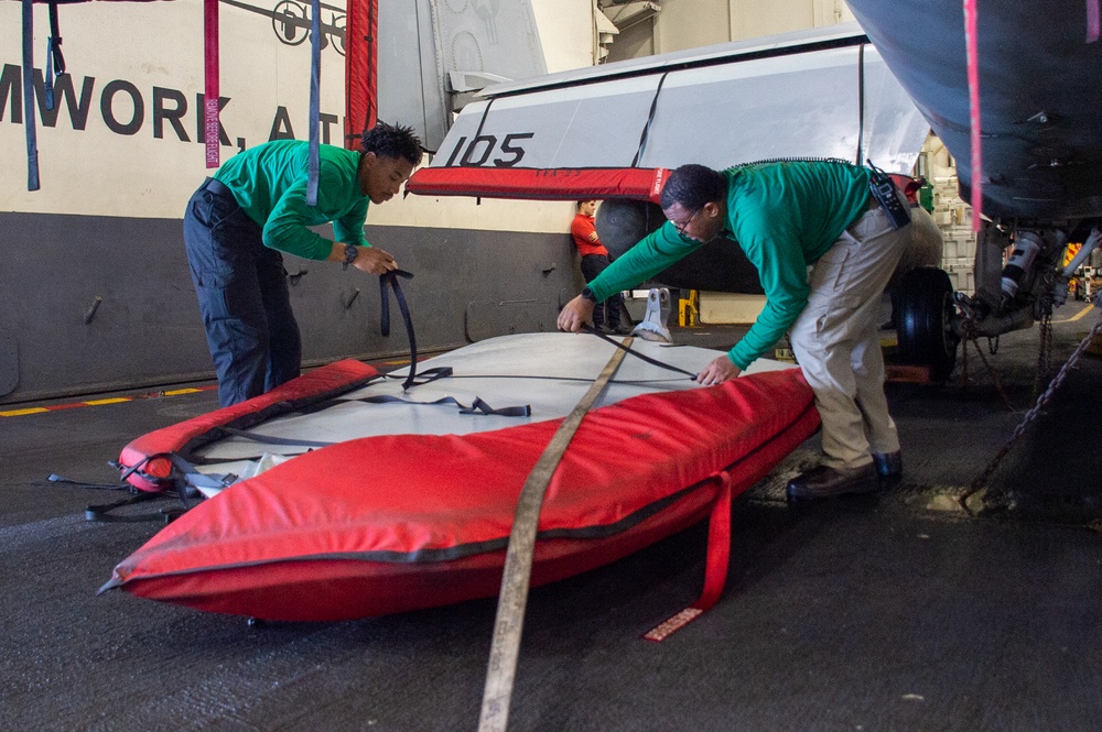 U.S. Navy Sailors Secure Aircraft Wing