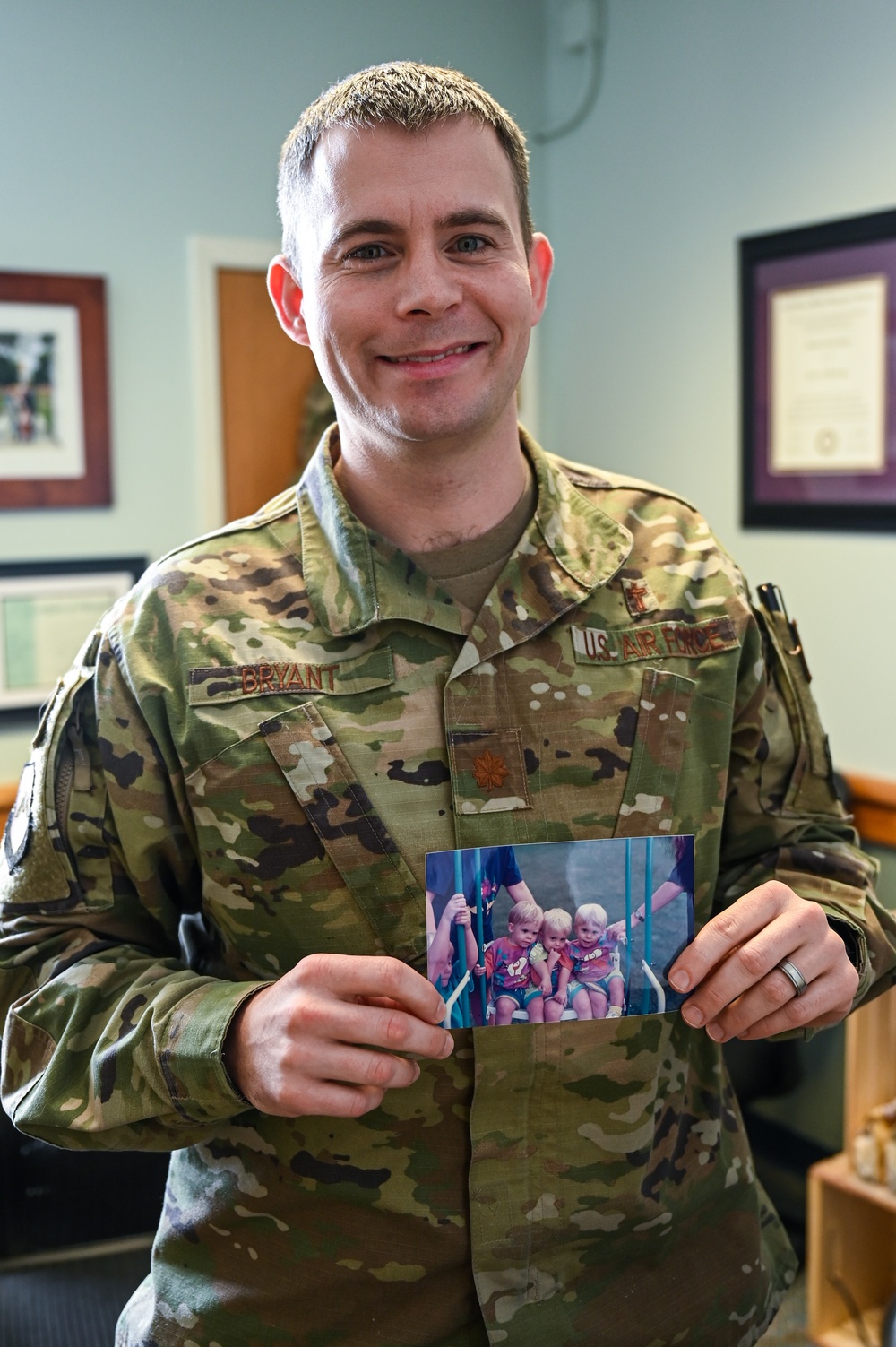 Chaplain holds a photo of his family