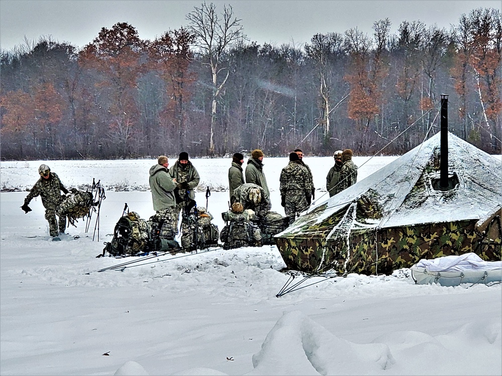 Airmen learn to build Arctic 10-person tents during cold-weather training at Fort McCoy