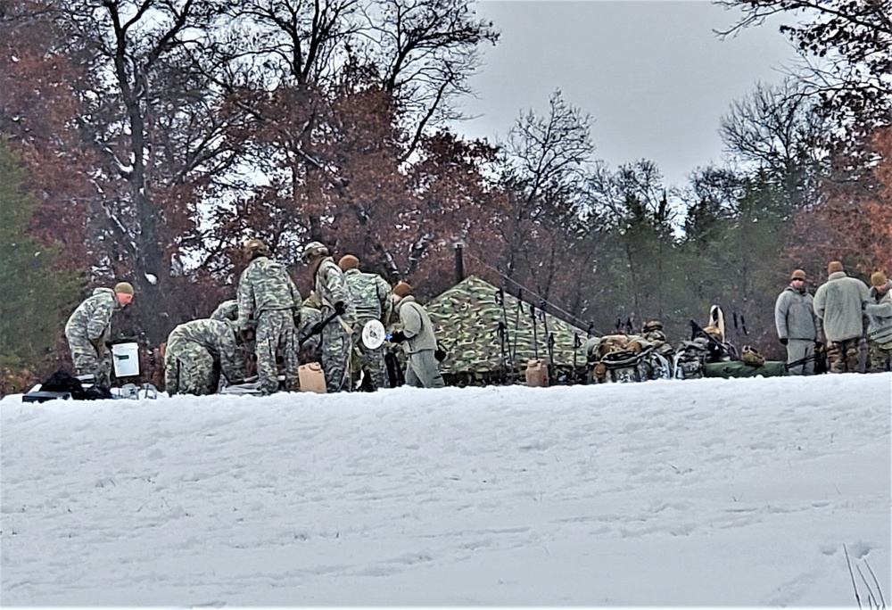 Airmen learn to build Arctic 10-person tents during cold-weather training at Fort McCoy