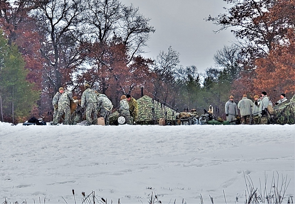 Airmen learn to build Arctic 10-person tents during cold-weather training at Fort McCoy