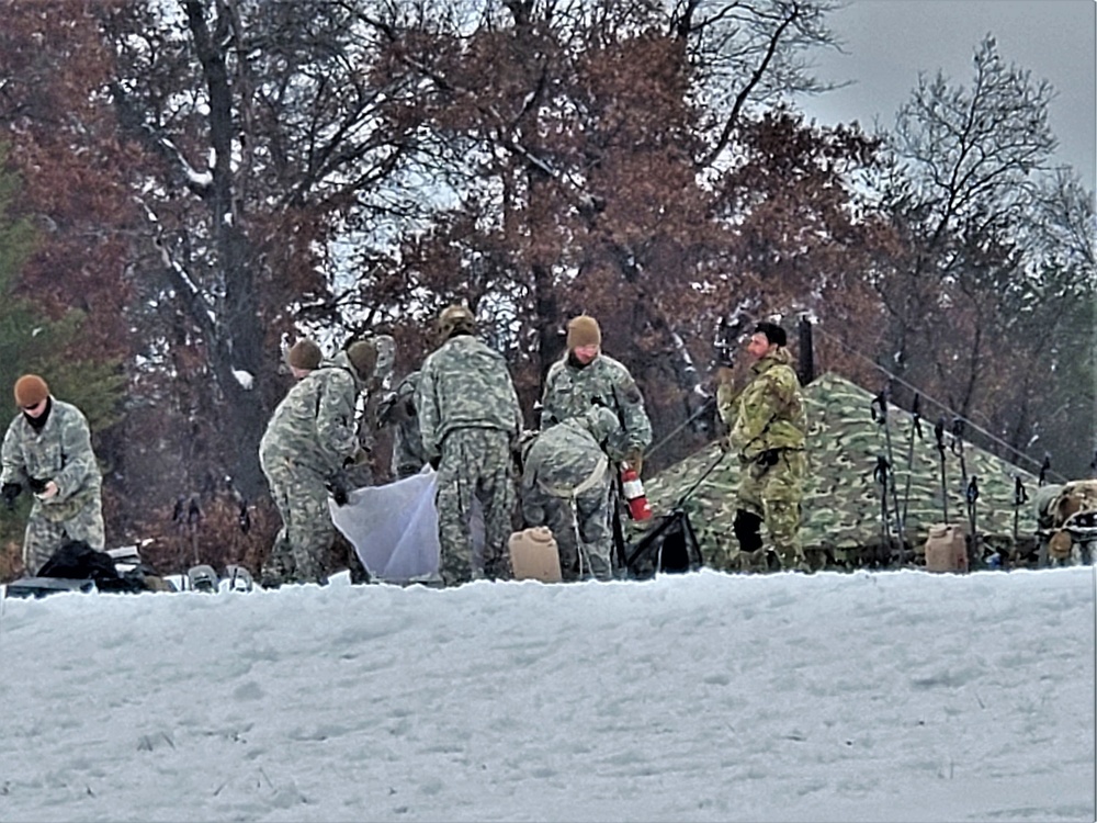 Airmen learn to build Arctic 10-person tents during cold-weather training at Fort McCoy