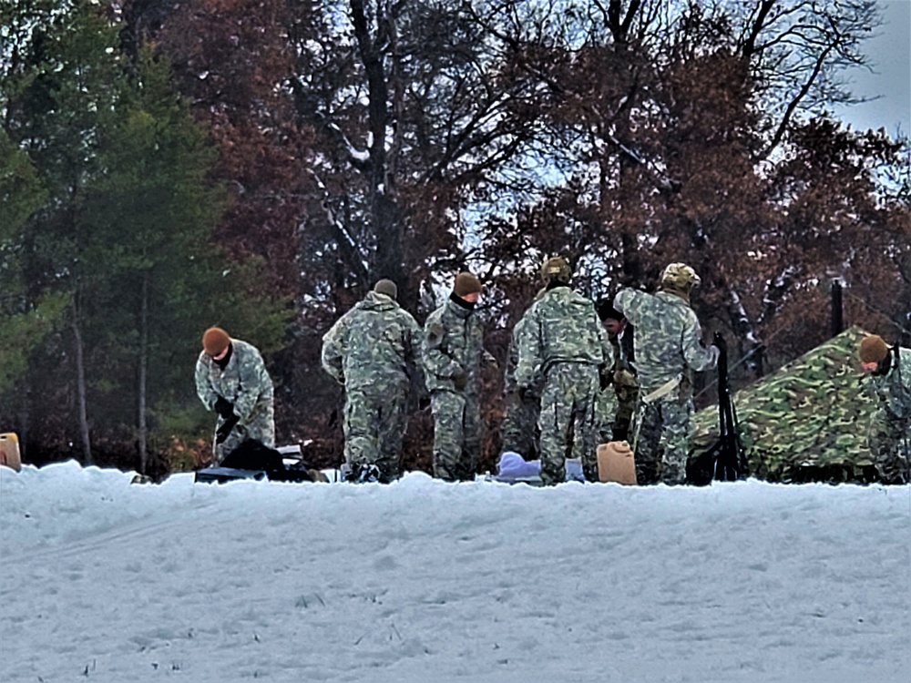 Airmen learn to build Arctic 10-person tents during cold-weather training at Fort McCoy