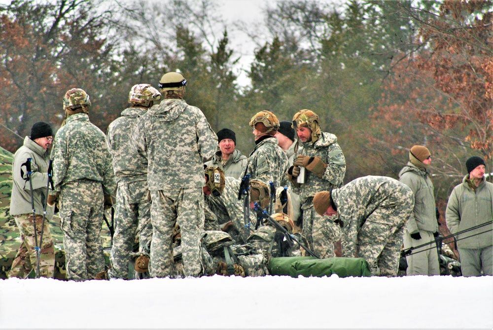 Airmen learn to build Arctic 10-person tents during cold-weather training at Fort McCoy