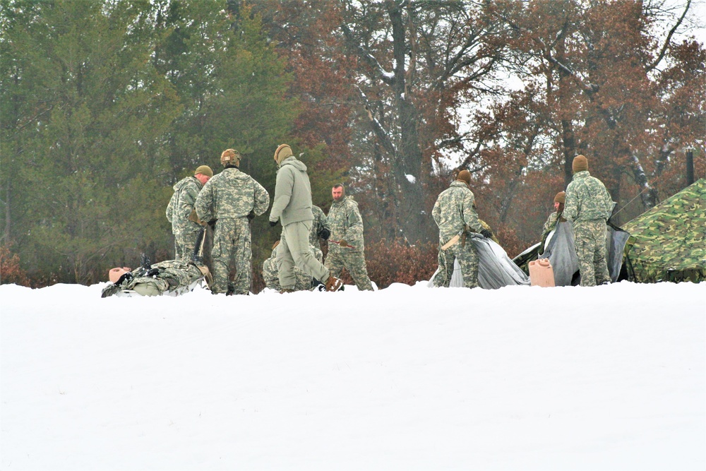 Airmen learn to build Arctic 10-person tents during cold-weather training at Fort McCoy