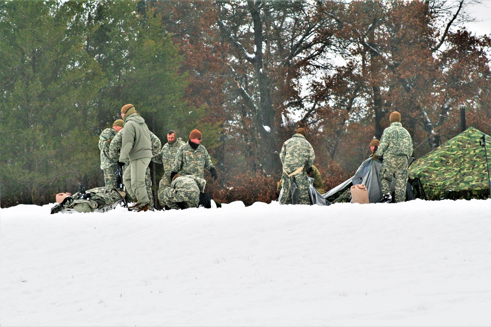 Airmen learn to build Arctic 10-person tents during cold-weather training at Fort McCoy