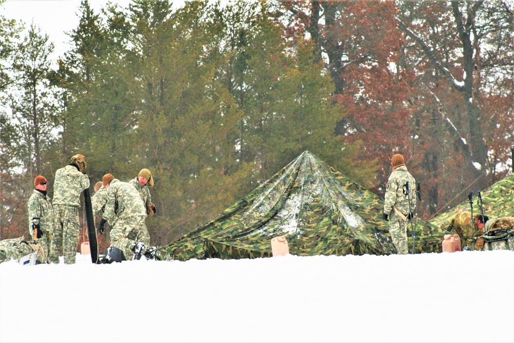 Airmen learn to build Arctic 10-person tents during cold-weather training at Fort McCoy