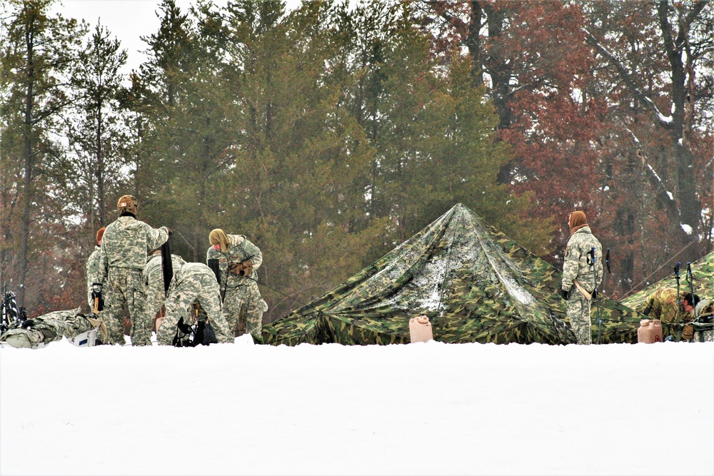 Airmen learn to build Arctic 10-person tents during cold-weather training at Fort McCoy