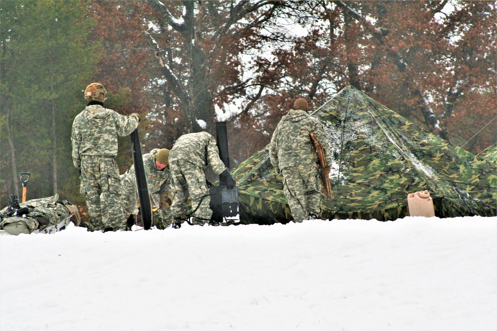 Airmen learn to build Arctic 10-person tents during cold-weather training at Fort McCoy