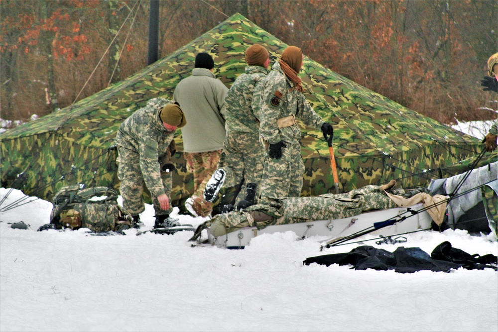 Airmen learn to build Arctic 10-person tents during cold-weather training at Fort McCoy