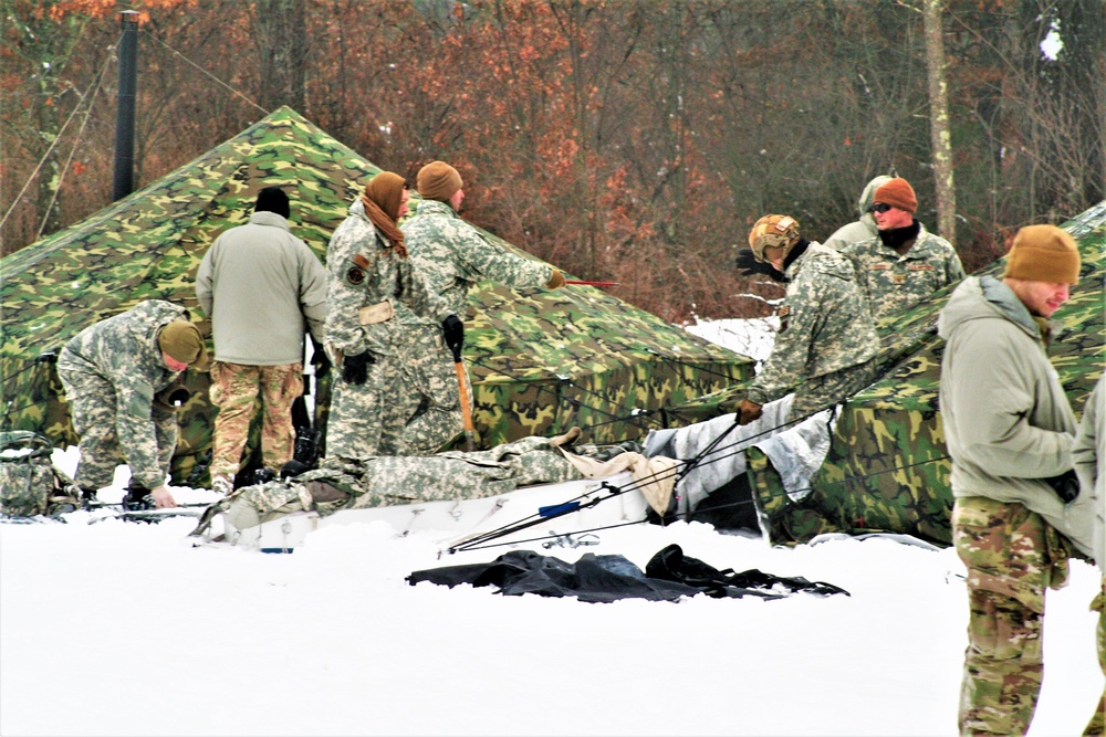 Airmen learn to build Arctic 10-person tents during cold-weather training at Fort McCoy