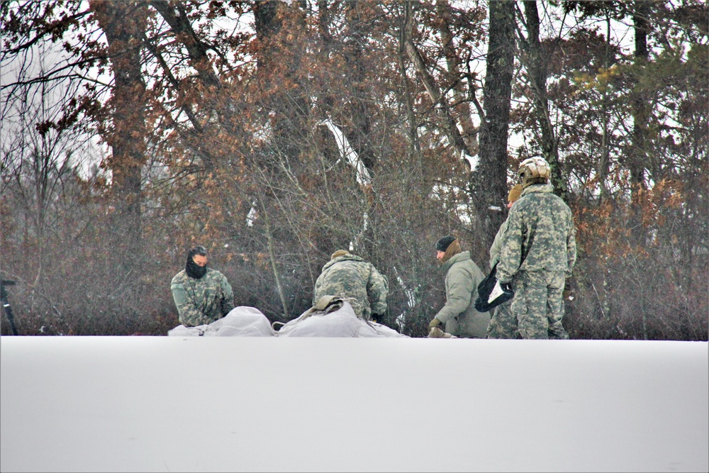 Airmen learn to build Arctic 10-person tents during cold-weather training at Fort McCoy