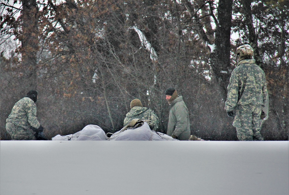 Airmen learn to build Arctic 10-person tents during cold-weather training at Fort McCoy