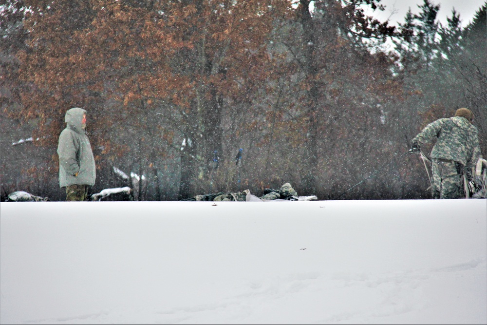 Airmen learn to build Arctic 10-person tents during cold-weather training at Fort McCoy