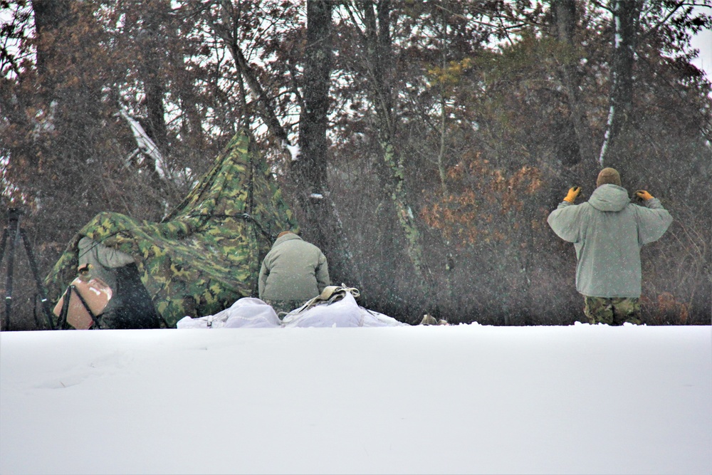 Airmen learn to build Arctic 10-person tents during cold-weather training at Fort McCoy