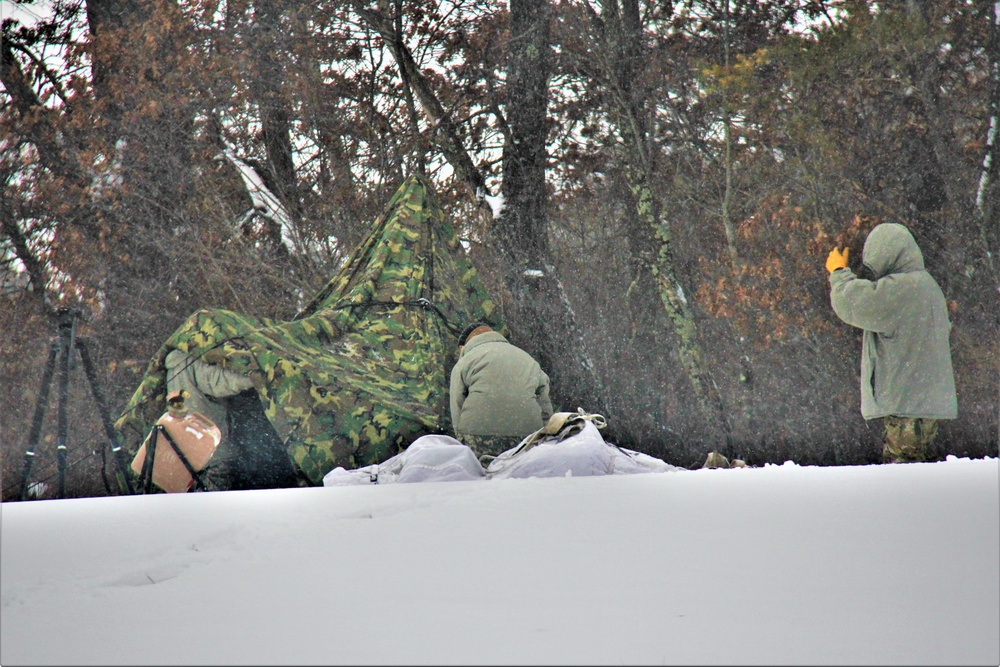 Airmen learn to build Arctic 10-person tents during cold-weather training at Fort McCoy