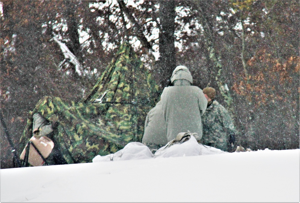 Airmen learn to build Arctic 10-person tents during cold-weather training at Fort McCoy