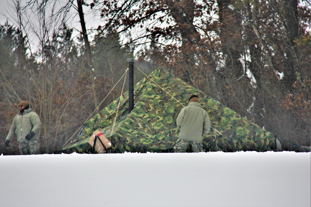 Airmen learn to build Arctic 10-person tents during cold-weather training at Fort McCoy