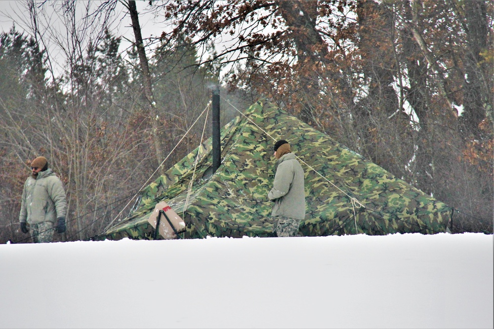 Airmen learn to build Arctic 10-person tents during cold-weather training at Fort McCoy