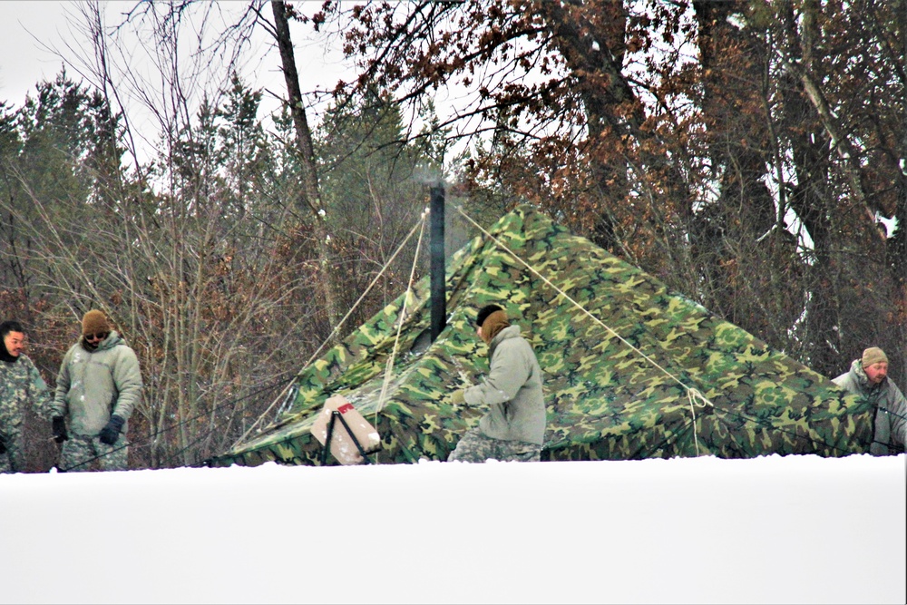 Airmen learn to build Arctic 10-person tents during cold-weather training at Fort McCoy