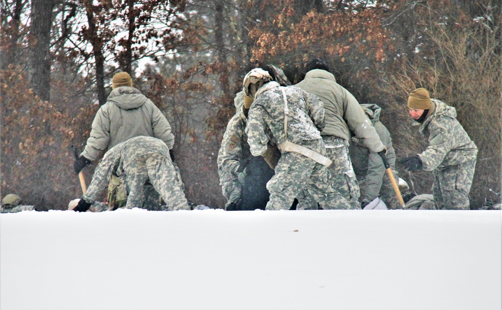 Airmen learn to build Arctic 10-person tents during cold-weather training at Fort McCoy