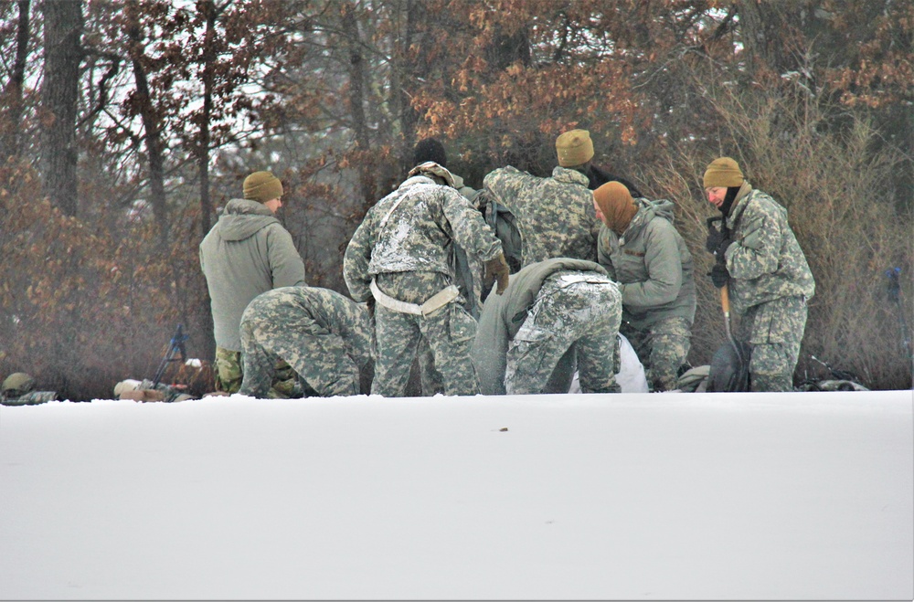 Airmen learn to build Arctic 10-person tents during cold-weather training at Fort McCoy