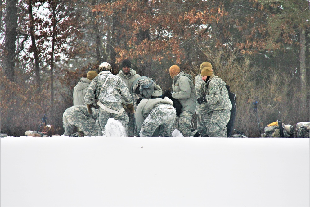 Airmen learn to build Arctic 10-person tents during cold-weather training at Fort McCoy