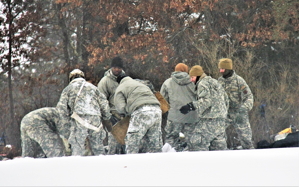 Airmen learn to build Arctic 10-person tents during cold-weather training at Fort McCoy