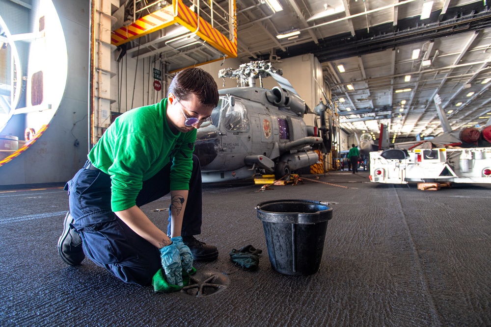 U.S. Navy Sailor Cleans Padeyes