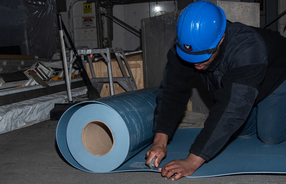 USS Ronald Reagan (CVN-76) Sailors prepare electrical matting