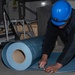 USS Ronald Reagan (CVN-76) Sailors prepare electrical matting