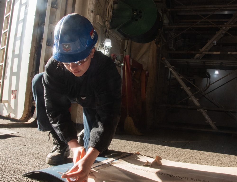 USS Ronald Reagan (CVN-76) Sailors prepare electrical matting